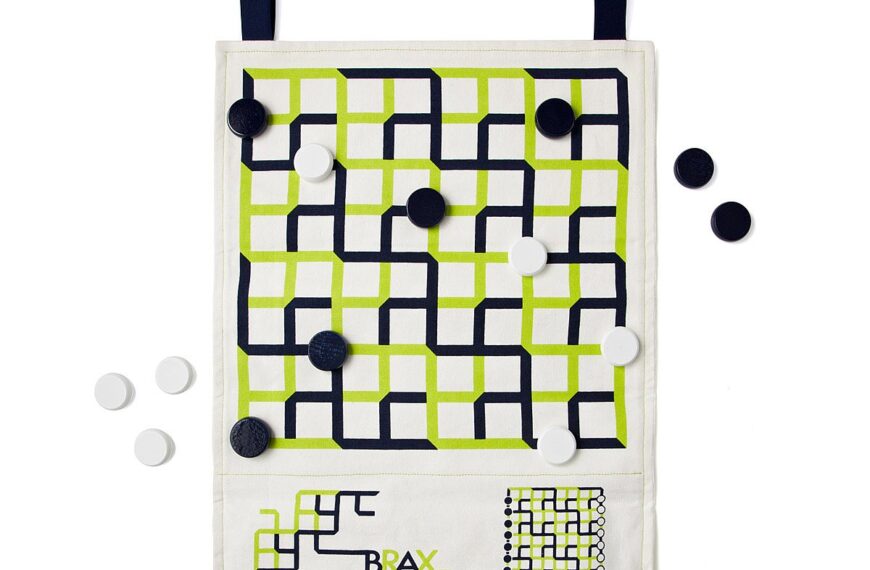 A fabric board game with a green and black grid pattern, black and white playing pieces, and a logo reading "BRAX" at the bottom.