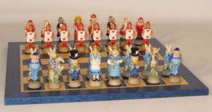 A themed chess set featuring characters from 'Alice in Wonderland' with pieces shaped like the White Rabbit, Alice, the Mad Hatter, and others, arranged on a chessboard.