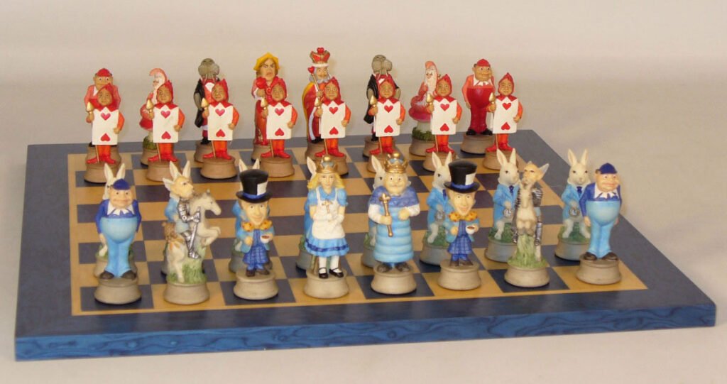 A themed chess set featuring characters from 'Alice in Wonderland' with pieces shaped like the White Rabbit, Alice, the Mad Hatter, and others, arranged on a chessboard.