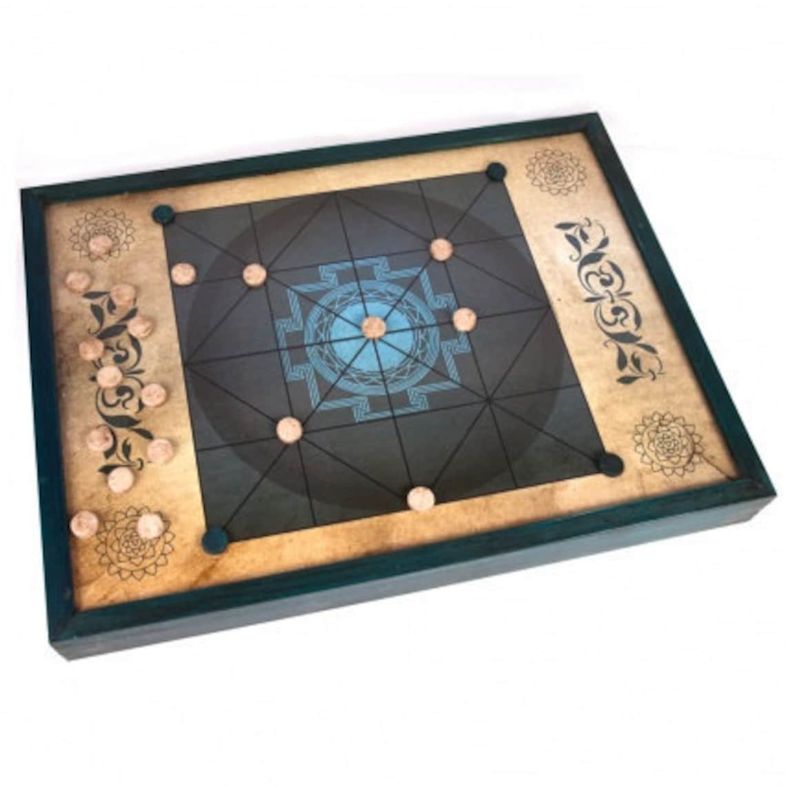 A Carrom board with black and beige patterns and designs on the surface, displayed against a white background.
