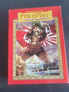 A board game box titled "Empire of the Rising Sun" with a stylized depiction of a samurai in armor against a backdrop of waving flags.