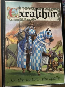 An illustration of a medieval knight on a blue and white checkered horse, with an Excalibur banner above and the phrase "To the victor...the spoils" below. Other figures, including a mounted knight and foot soldiers, are in the background.