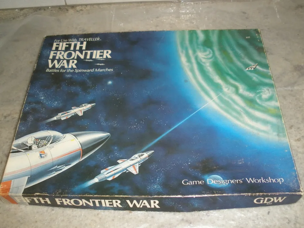 The image shows a worn board game box for "FIFTH FRONTIER WAR" featuring artwork of three spaceships engaged in a skirmish against a backdrop of a starry sky and a swirling green nebula. The text on the box indicates the game is for use with "TRAVELLER" and is for "Battles for the Spinward Marches" by Game Designers' Workshop (GDW).