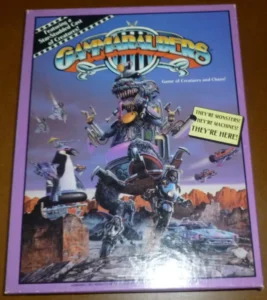 Box cover art for "Gammarauders," a tabletop game, featuring colorful, cartoon-style monsters and mechanical creatures in a chaotic desert landscape. Text on the cover includes "Game of Creatures and Chaos!" and slogans "They're monsters! They're machines! They're here!"