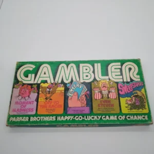 Vintage "Gambler" board game box by Parker Brothers with colorful illustrations and text describing the happy-go-lucky game of chance.