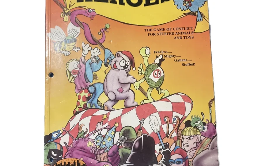 The image shows the cover of a game titled "FUZZY HEROES," described as "THE GAME OF CONFLICT FOR STUFFED ANIMALS AND TOYS," featuring colorful illustrations of animated stuffed animals and toys in various heroic poses, with the logo of Inner City Games Designs at the bottom. The cover has noticeable wear and a hole punched in the upper left corner.