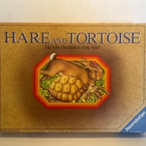 Board game box cover reading "HARE AND TORTOISE - He who hesitates may win!" with an illustration of a hare lying on top of a tortoise against a green, flora-filled background, by Ravensburger.