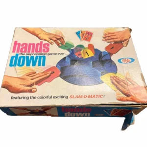 Vintage "Hands Down" board game box with an image showing hands slamming down on a colorful game unit with cards, labeled as "the slaphappiest game ever... featuring the colorful exciting SLAM-O-MATIC!" by IDEAL.
