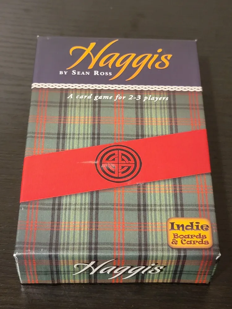 A boxed card game titled "Haggis" by Sean Ross, designed for 2-3 players, with a tartan pattern and a red band bearing a logo, along with an "Indie Boards & Cards" sticker.