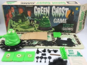 Vintage "Green Ghost Game" by Transogram displayed with box, board, green ghost figure, cards, and game pieces, including bats, keys, and bones.