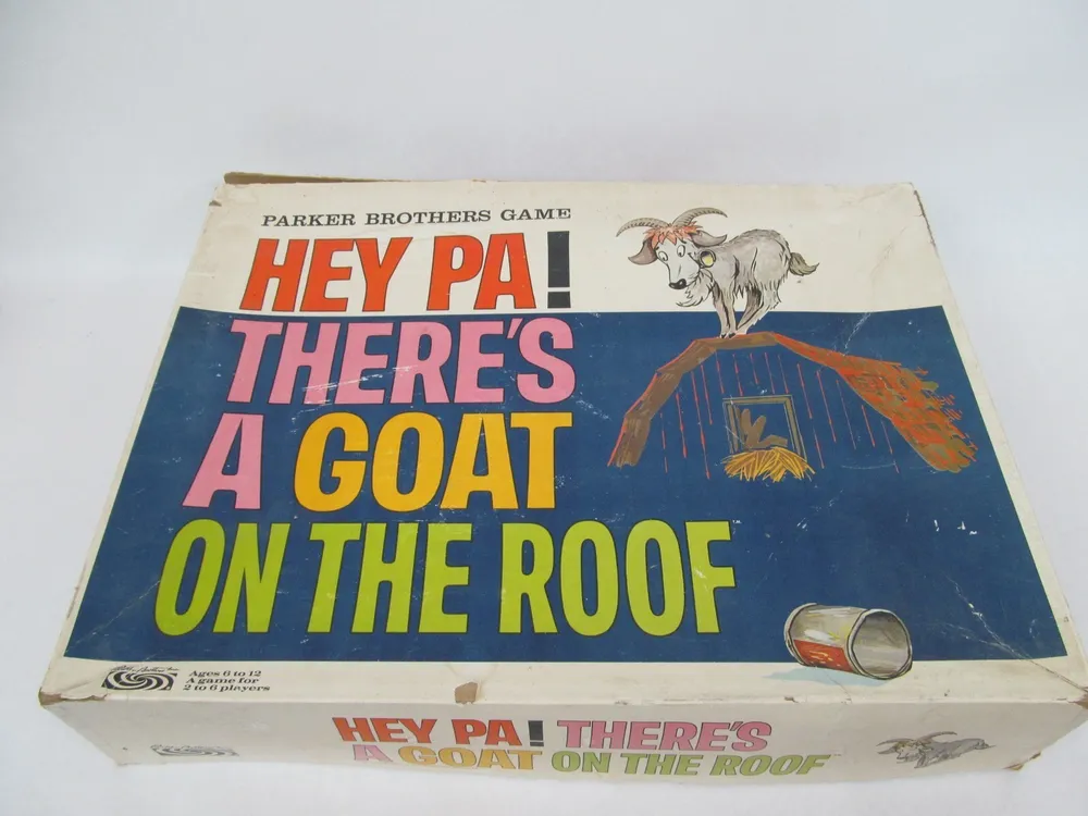 Vintage Parker Brothers board game box titled "HEY PA! THERE'S A GOAT ON THE ROOF" with colorful text and an illustrated goat standing on a barn roof.