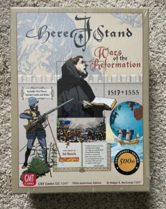 This is an image of the board game "Here I Stand: Wars of the Reformation 1517-1555," featuring artwork of a monk with a quill and book, a soldier with a pike, historical battle scenes, and a globe with sailing ships. The game is described as a 500th Anniversary Edition by GMT Games LLC, designed by Ed Beach, and the box includes a 500th-anniversary emblem and credits for the artwork.