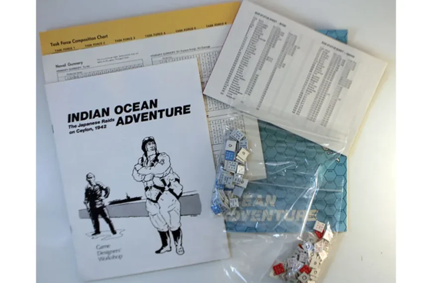 An assortment of board game components including a rule book titled "INDIAN OCEAN ADVENTURE The Japanese Raids on Ceylon, 1942," several printed charts, and a plastic bag containing hexagonal tiles and dice.