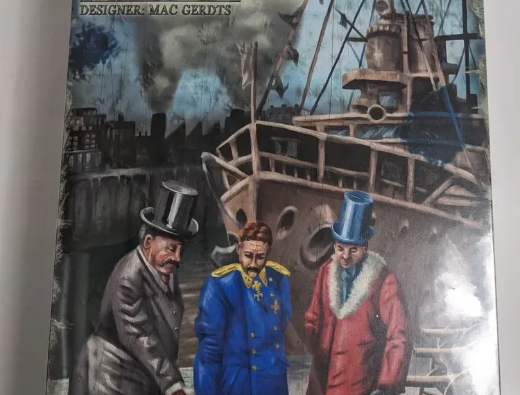 Board game cover titled "IMPERIAL" with artwork of three men in historical dress, examining a map with a ship and industrial backdrop, "Designer: Mac Gerdts" written at the top, and "Rio Grande Games" logo at the bottom.