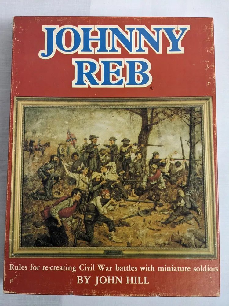 A book cover for "JOHNNY REB" with an illustration of Civil War soldiers in battle, including text on the bottom reading "Rules for re-creating Civil War battles with miniature soldiers BY JOHN HILL."