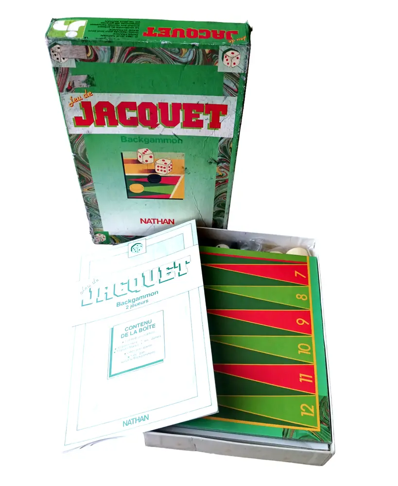 A worn "Jeu de Jacquet" backgammon board game box with the board and game rules booklet visible.