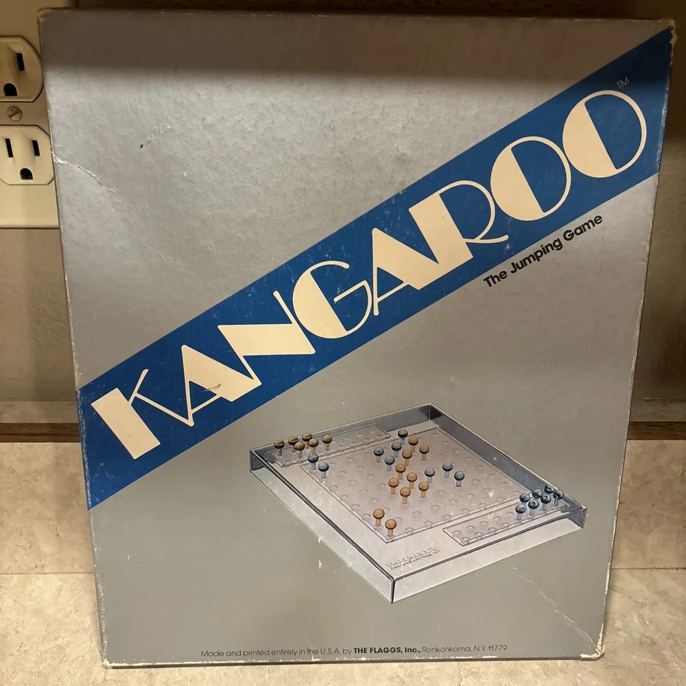 A game box for "KANGAROO The Jumping Game" with an image of the board game on the front, indicating it was made and printed in the USA. The box shows some wear and is placed on a tiled floor.