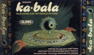 Vintage board game "ka-bala" packaging with a large eye illustration, highlighting glow-in-the-dark feature, tarot cards, and astrological aspects, labeled as a game that foretells the future.