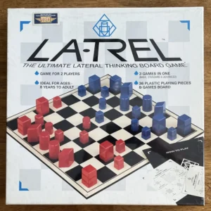 A board game called 'LA-TREL The Ultimate Lateral Thinking Board Game' is displayed on a table, with a chessboard-like pattern containing red and blue plastic pieces, ideal for 2 players and designed for ages 8 to adult, including a rule sheet with instructions on how to play.