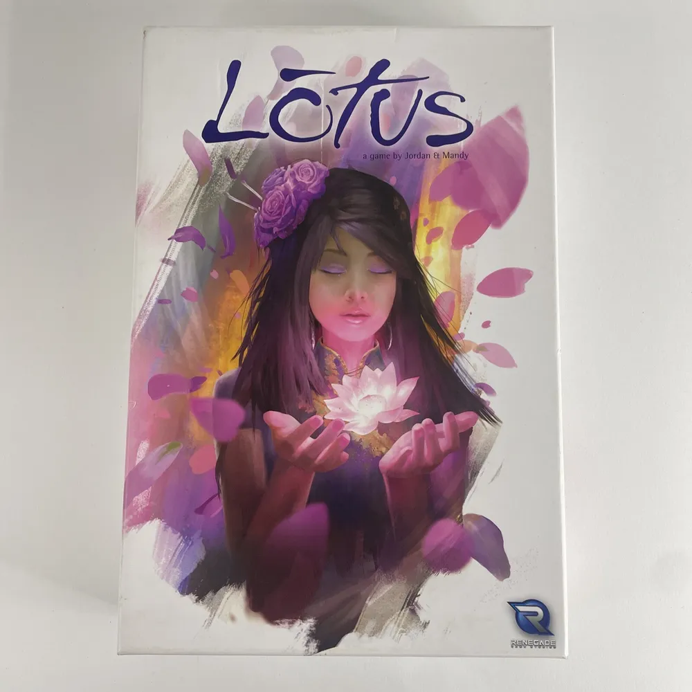 The image shows the cover of "Lotus," a board game by Jordan and Mandy, featuring artwork of a woman with closed eyes, gently holding a glowing white lotus flower, surrounded by purple petals. The Renegade Game Studios logo is visible at the bottom right corner.