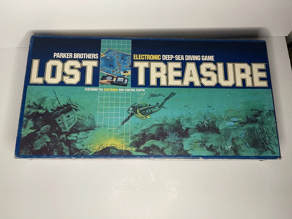 Vintage "Lost Treasure" board game by Parker Brothers, featuring an underwater scene with sunken ships and treasure, and the tagline "Electronic Deep-Sea Diving Game".