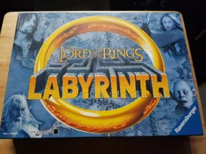 "The Lord of the Rings" Labyrinth board game box by Ravensburger featuring images of characters from the movie on a map-like background.