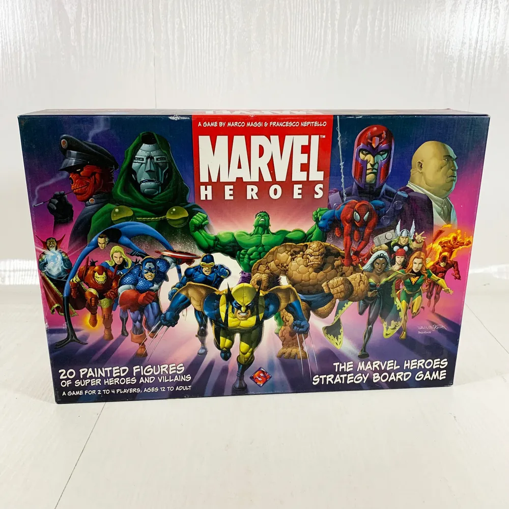 A "Marvel Heroes" strategy board game box featuring various Marvel superheroes and villains with the text "20 Painted Figures of Super Heroes and Villains. A game for 2 to 4 players, ages 12 to adult."