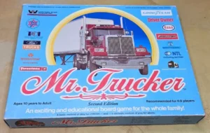 A "Mr. Trucker Second Edition" board game box for ages 10 to adult and for 4-8 players, featuring a red truck on the cover with various corporate logos and the tagline "An exciting and educational board game for the whole family!"