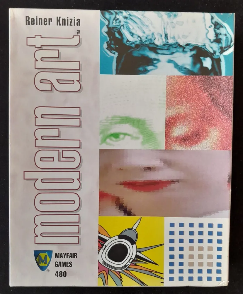 A photo of the "Modern Art" board game box by Reiner Knizia, published by Mayfair Games, featuring a collage of various abstract and modern art images including a splash of water, a close-up of a face, and graphical patterns.