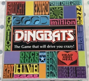 The image is a box cover for the board game "Dingbats," featuring colorful, bold text and various word puzzles arranged in a grid pattern, with the tagline "The Game that will drive you crazy!"