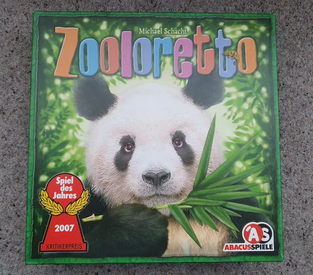 Board game cover featuring a large image of a panda with a bamboo background, titled "Zooloretto" by Michael Schacht, with the Spiel des Jahres award for 2007 and the ABACUSSPIELE logo.