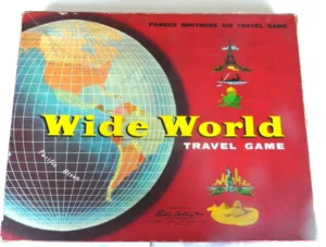 Vintage "Wide World Travel Game" board game by Parker Brothers with a red background featuring a globe, landmarks, and an airplane illustration.