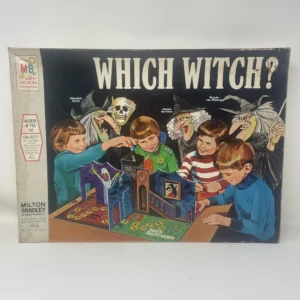 A worn vintage board game box titled "WHICH WITCH?" by Milton Bradley showing an illustration of three children playing the game with a haunted house setup on the board, accompanied by cartoonish witch and ghost figures. The box indicates the game is for ages 6 to 12 and includes a slogan, "A KEY TO FUN and learning."