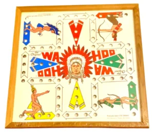 A vintage "Wahoo" board game with colorful illustrations of Native American figures and traditional game paths marked with holes for pegs, encased in a wooden frame.