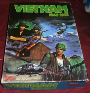 A vintage game box titled "VIETNAM 1965-1975" featuring artwork with soldiers in combat, helicopters in the sky, and a burning hut in the background. The bottom of the box displays the logo of Victory Games.
