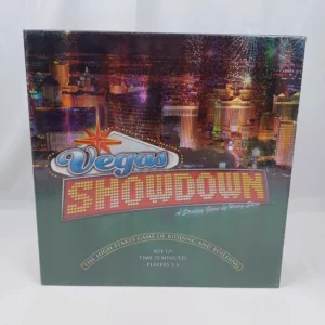 Board game titled "Vegas Showdown" with an image of the Las Vegas skyline at night, featuring fireworks and bright lights. Text on the box indicates it is a strategy game by Henry Stern for ages 12+, has a playing time of 75 minutes, and is suitable for 3-5 players.