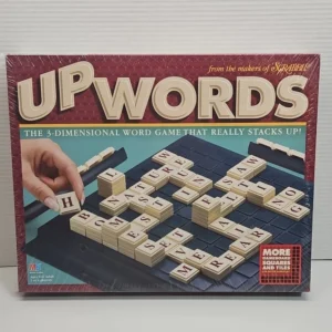 The image shows the box of a 3-dimensional word game called Upwords, indicating it is from the makers of Scrabble. The box art features the game's name in large 3D letters at the top and a depiction of the game in play, with multiple layers of letter tiles stacked on a square grid board. A human hand is shown placing an 'H' tile on the game board. There's also text highlighting that the game is suitable for ages 8 to adult and 2 to 4 players, and a red badge in the corner mentions more gameboard squares and tiles.