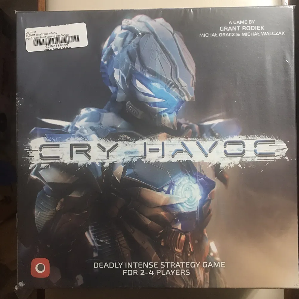 An image of a board game called "Cry Havoc," featuring artwork of an armored futuristic soldier with a helmet and chest device emitting blue light. The cover states it is a deadly intense strategy game for 2-4 players, created by Grant Rodiek, Michal Oracz & Michal Walczak. A price tag is on the top left corner.