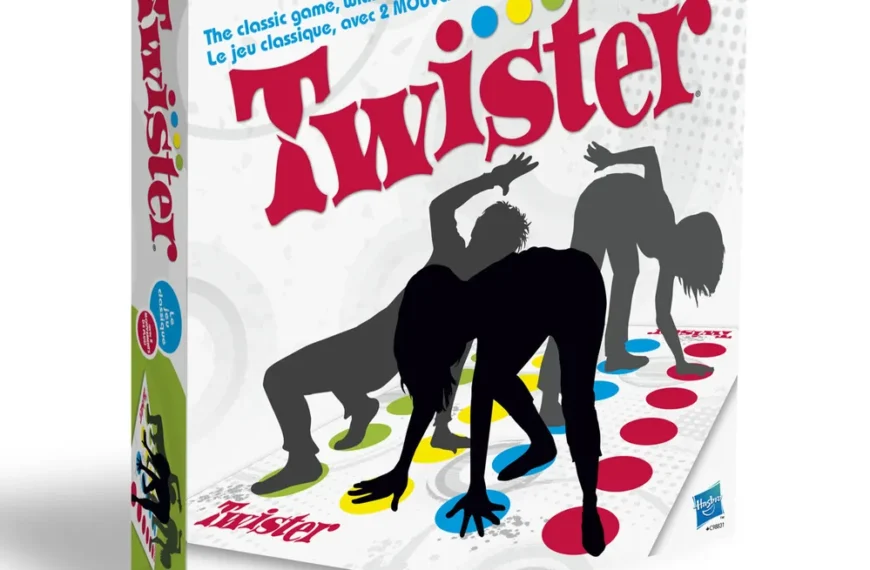 A boxed Twister board game with an illustration showing silhouettes of two people playing, twisting their arms and legs on the colored dots. Text indicates "The classic game, with 2 MORE MOVES!" and "AGE 6+", as well as branding and manufacturer logos.
