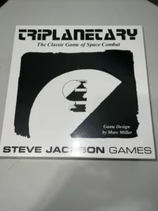 Box cover of "Triplanetary – The Classic Game of Space Combat" by Steve Jackson Games with game design by Marc Miller, featuring a black and white design with a spaceship graphic.