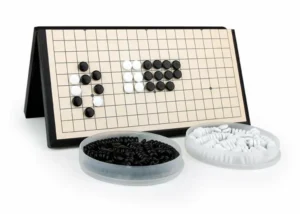 A Go game board with a game in progress, featuring black and white stones placed on the grid, and separate bowls with additional black and white stones.