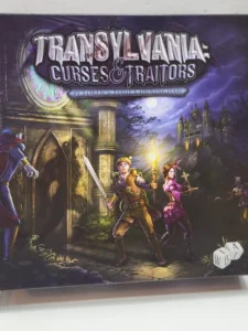 Alt text: Box cover art for the "Transylvania: Curses & Traitors" board game, featuring illustrated characters—a man in the foreground with a sword and a woman holding a lantern—poised for adventure, with a mysterious castle in the background under a twilight sky.