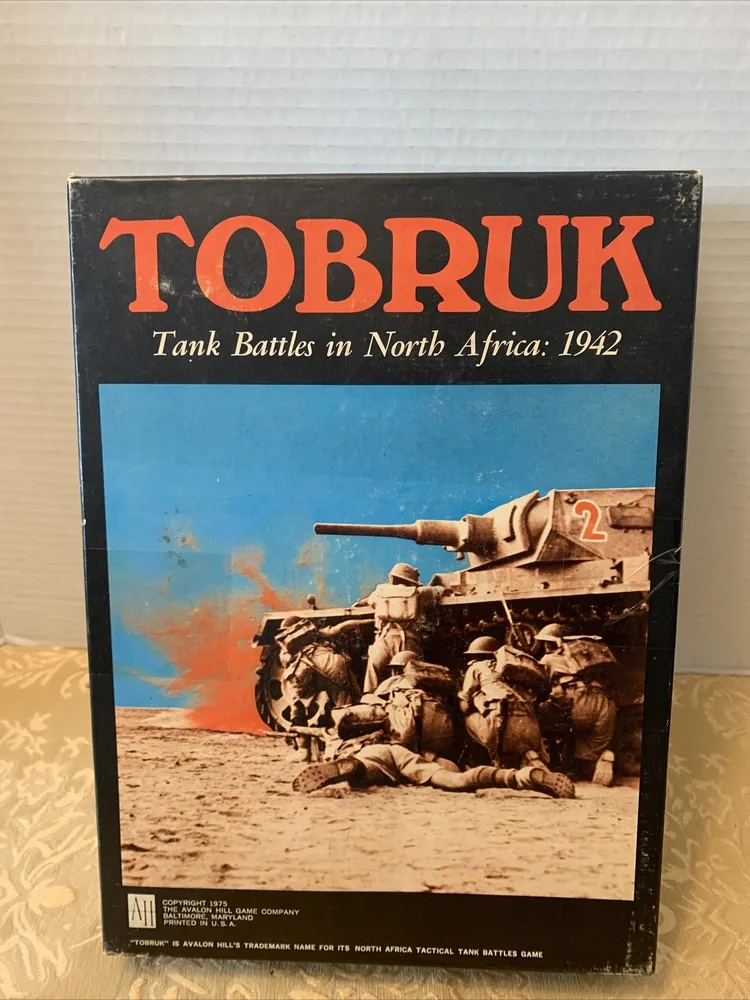 "Box cover of the 'TOBRUK Tank Battles in North Africa: 1942' board game, showing illustrated soldiers in combat beside a tank with an explosion in the background."