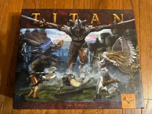 An image of a board game cover with the title "TITAN," featuring a fantasy battle scene with various mythological creatures and warriors engaged in combat.