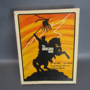 Vintage "The Warlord Game" board game box with silhouetted knight on horseback and dragon against an orange background with lightning bolts. Text reads "If I were KING... YOU CAN BE as you take over FIEFS and accumulate WEALTH." Graphic design credit at the bottom.