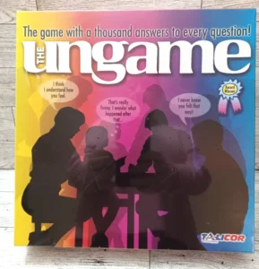 A board game box titled "The Ungame" with the tagline "The game with a thousand answers to every question!" showing silhouettes of four people engaged in conversation, speech bubbles, and an "Award Winner" badge at the top right corner. The logo of "TALICOR Aristoplay" is at the bottom right.