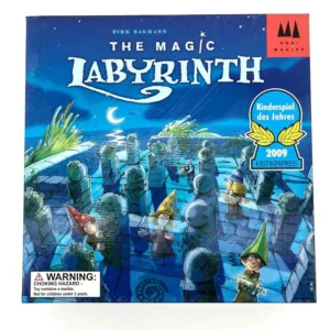 A board game cover titled "The Magic Labyrinth" by Dirk Baumann featuring colorful illustrations of wizards navigating a maze with pillars, set against a starry night sky, and with awards badges for 'Kinderspiel des Jahres 2009' and 'Kritikerpreis'. A choking hazard warning is present at the bottom left corner.