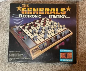 The image shows a vintage "The Generals Electronic Strategy Game" board game box with a 3D chessboard illustration, various military rank pieces, and an "Electronic Brain" emblem on the front.