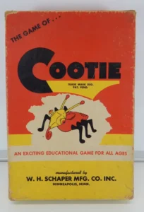 Vintage "The Game of Cootie" board game box with a cartoon illustration of a colorful bug, labeled as an exciting educational game for all ages by W. H. Schaper Mfg. Co. Inc., Minneapolis, Minn.