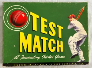 Vintage "Test Match" cricket board game cover featuring a red cricket ball and an illustration of a batsman in whites playing a shot, with text labeling it as a fascinating cricket game produced in Australia by John Sands Pty. Ltd.
